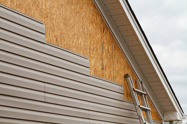 Professional Siding technician working in West Newton, MA